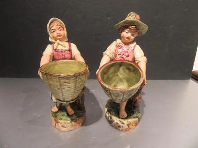two figurines that are sitting on a table