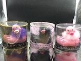 three candles are sitting on a counter in front of a television