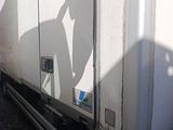 a man standing on the back of a white truck