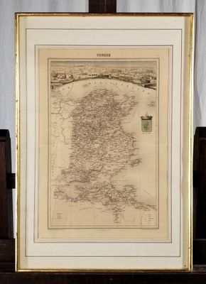 an old map of ireland in a frame on a table
