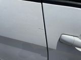 a close up of a door handle on a white car