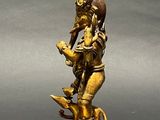 brass statue of a person riding a horse with a bird on its back