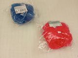 two bags of blue and red items on a white towel