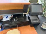 an image of a cash register and a pos terminal on a desk