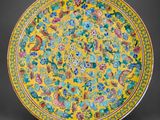 a yellow and green plate with floral designs on it