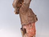 a figurine of a boy with a bird in his hand