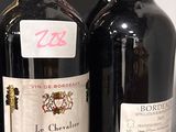 three bottles of wine sitting on a shelf next to each other