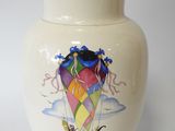 a white vase with a picture of a kite on it