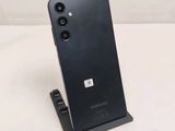 a close up of a cell phone on a stand on a table