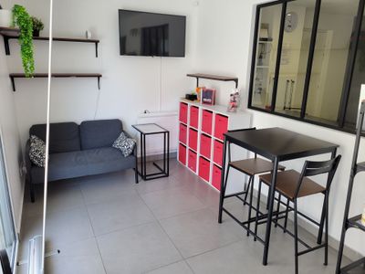 two pictures of a living room with a couch and a table