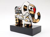 sculpture of an elephant on a black stand with a white background