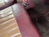 a picture of a red and tan seat in a car