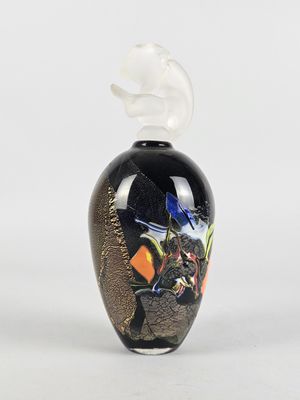 an image of a black vase with a bird on top of it