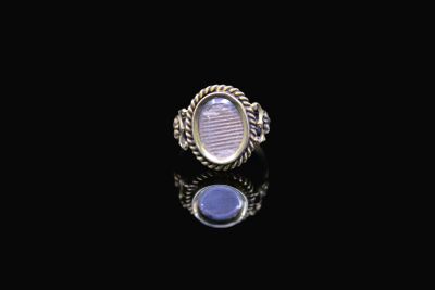 a close up of a ring on a black surface