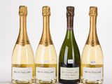 three bottles of champagne are lined up in a row