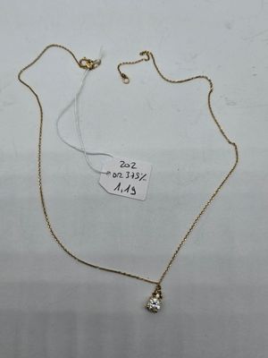 a gold necklace with a small diamond on a chain