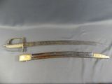 pair of antique swords with brass handles on display in a case