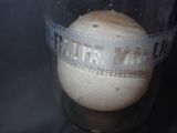 a glass with a ball inside of it on a table