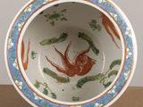a bowl that has a bird on it on a table