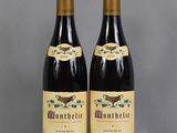 two bottles of wine sitting next to each other on a table