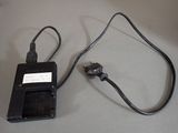 a cell phone plugged into a charger on a table