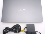 a laptop with a power cord and a charger attached to it