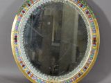 an image of a round mirror with a colorful border around it