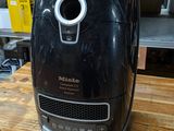 a black air fryer sitting on a wooden table
