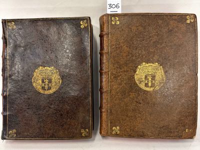 an old book with a gold emblem on the front and a brown book with a gold emblem on the back