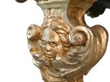 a gold vase with a bird on top of it