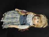 a doll with blonde hair and a blue dress