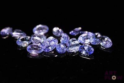 a pile of tanzan gems on a black surface
