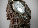 a clock that is sitting on top of a tree stump