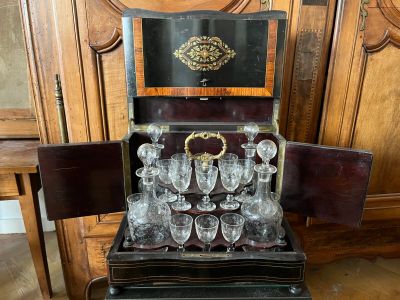 a wooden cabinet with a wine glass set in it