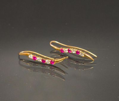 pair of ruby and diamond earrings on a black surface