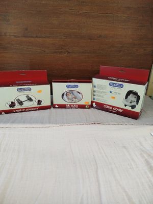 three boxes of baby products sitting on top of a bed