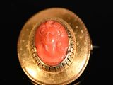 an image of a gold ring with a red stone in the center