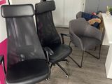 two black office chairs in the corner of a room