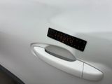 a close up of a car door handle with a sticker on it