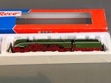 a green and red train in a box on a table