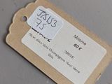 a tag on a piece of paper on a table