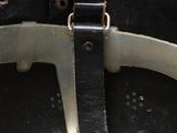 a close up of a helmet with a leather strap on it