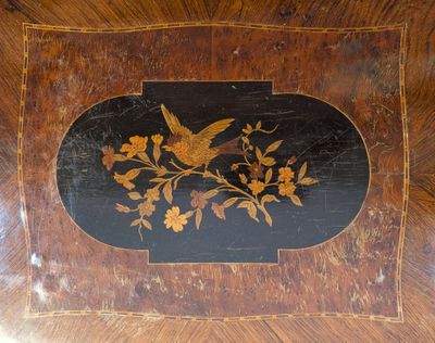 a picture of a wooden table with a bird and flowers on it