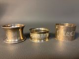 three silver cups sitting on top of a table next to each other