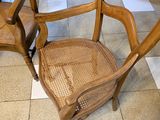 a wooden chair that is sitting on a tile floor
