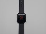 a close up of a black apple watch on a white surface