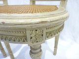 a white table with a wicker seat on it