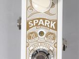 a close up of a white and gold electric guitar pedal over a white background