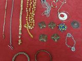 many different types of jewelry on a red surface