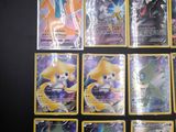 a lot of pokemon cards that are on the table